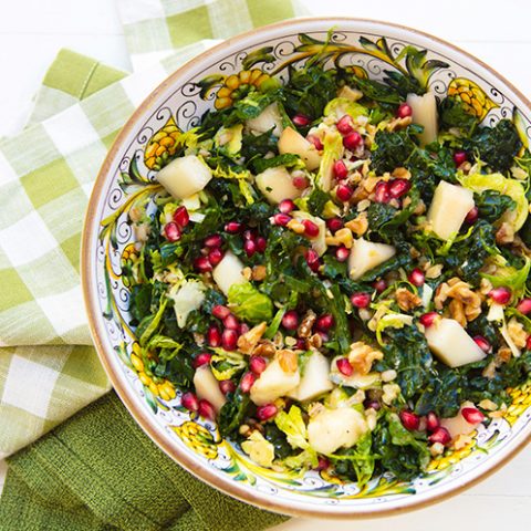 Kale, Barley, & Shredded Brussels Sprouts Salad With Pears, Walnuts, & Pomegranate Arils